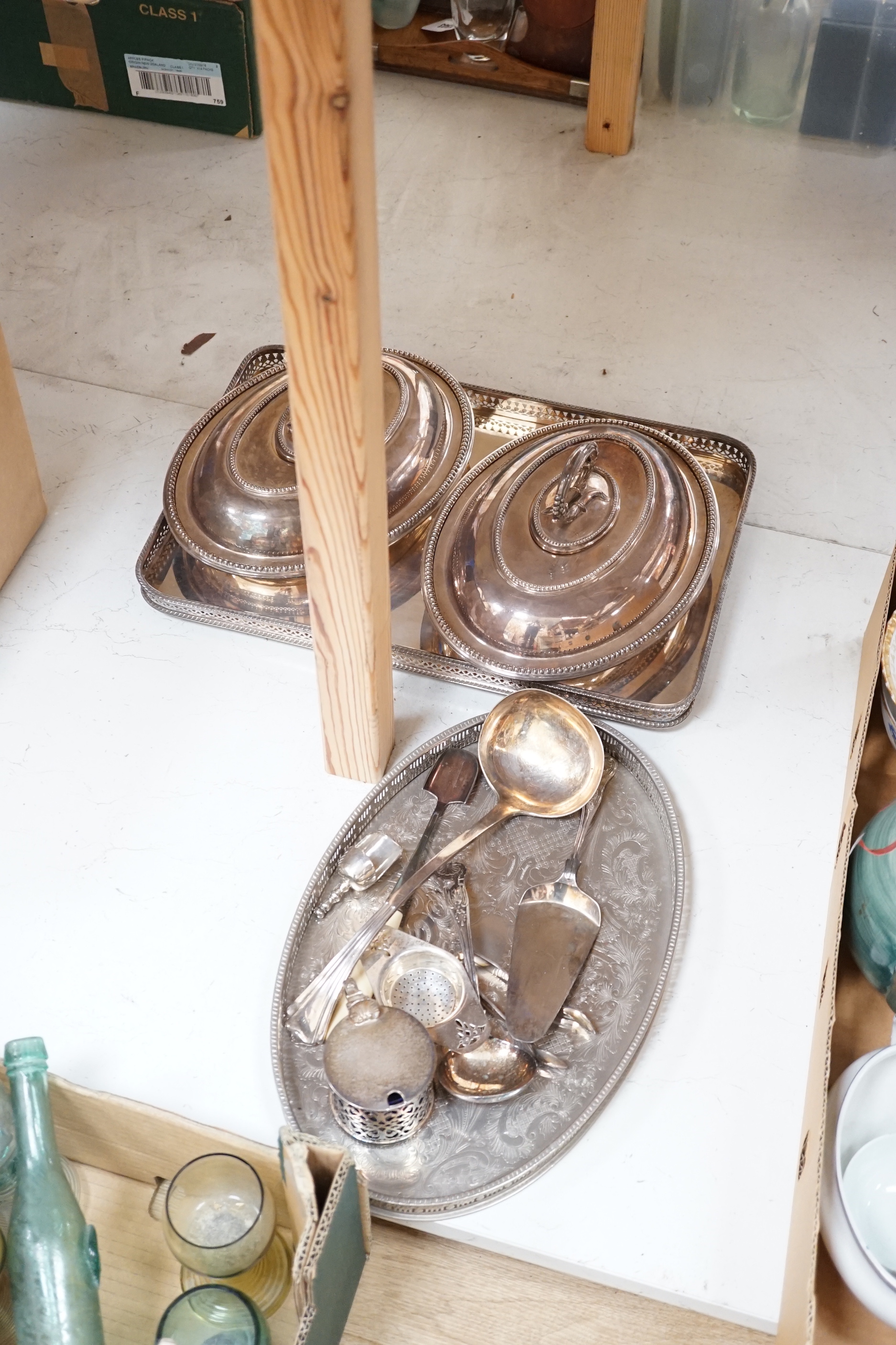 A pair of plated tureens, an oval tray, a basket, three branch candelabra, etc.